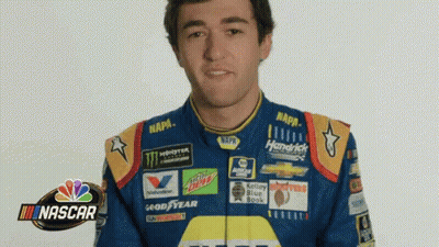 Man In Blue And Yellow NASCAR Jacket Making Funny Face GIF