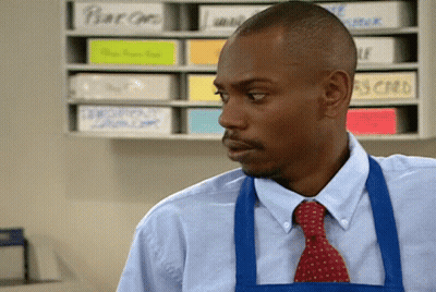 Man In Blue Apron And Tie With Pear Boxes GIF