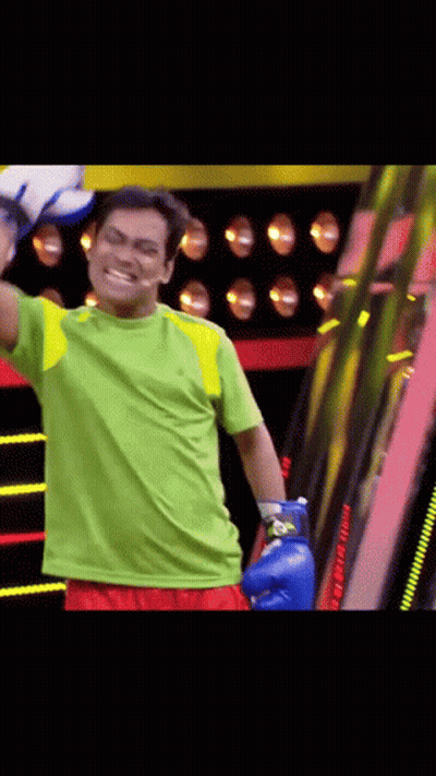 Man In Blue Boxing Gloves And Green Shirt GIF