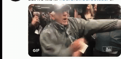 Man In Blue Brew Crew Sweatshirt In Front Of Scoreboard GIF