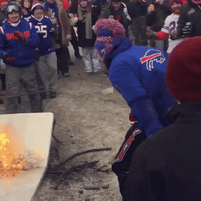 Man In Blue Buffalo Bills Jersey Standing In Front Of Fire GIF