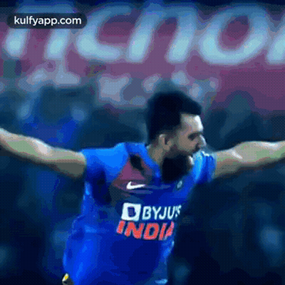 Man In Blue Byju's India Jersey Arms Outstretched GIF