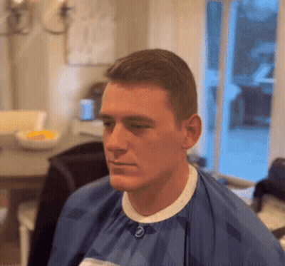 Man In Blue Cape With Letter E On Collar GIF