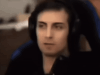 Man in Blue Chair Wearing Headphones Facing Camera