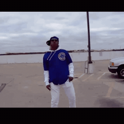 Man in Blue Chicago Cubs Jersey Standing in Parking Lot