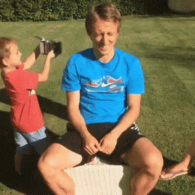 Man In Blue Dolphin Shirt Next To Boy GIF