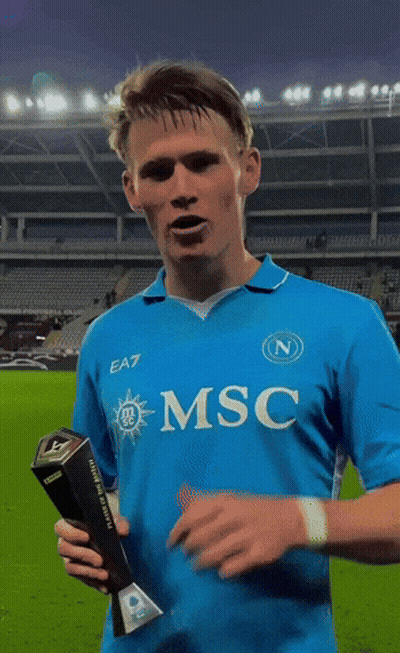Man In Blue EA7 Shirt Holding Trophy GIF