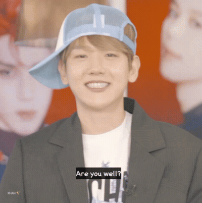 Man In Blue Hat And Black Jacket Says Are You Well GIF