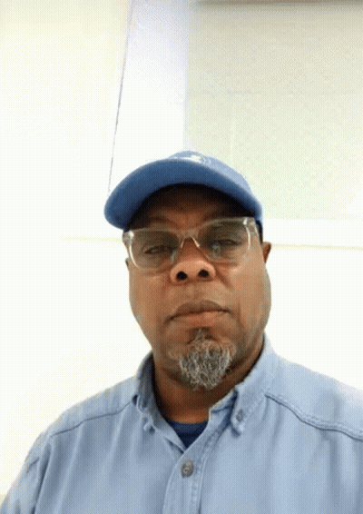 Man In Blue Hat And Glasses Looking At Camera GIF