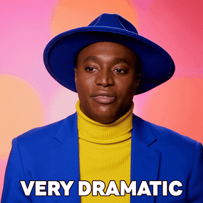 Man In Blue Hat And Yellow Turtleneck Very Dramatic GIF