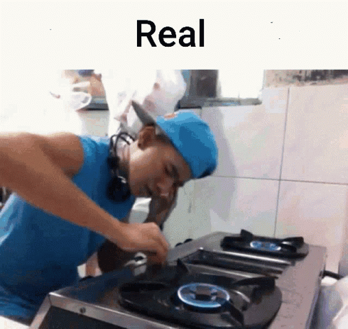 Man in Blue Hat Cooking With Word Real Above