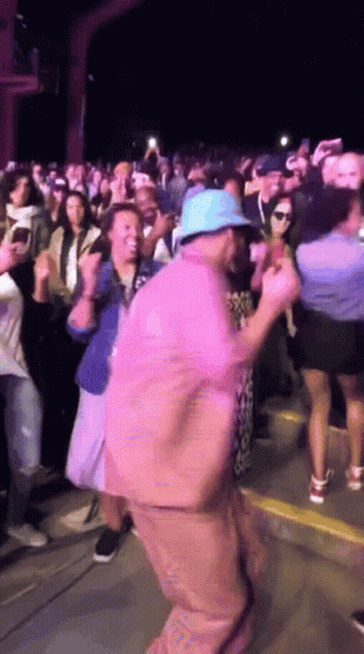 Man In Blue Hat Dancing In Front Of Crowd GIF