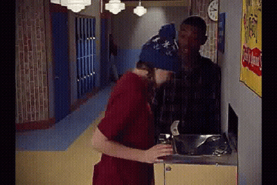 Man In Blue Hat Drinking From Water Fountain GIF
