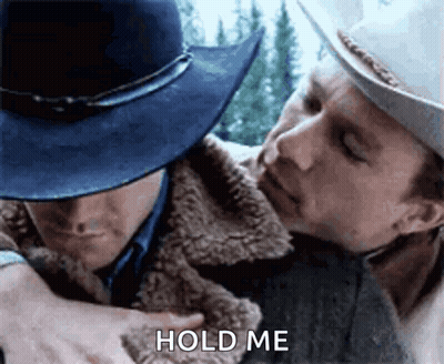 Man In Blue Hat Hugging Cowboy GIF