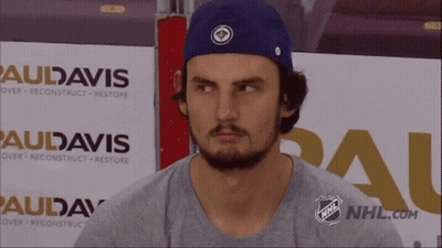 Man In Blue Hat In Front Of Audavis Sign GIF