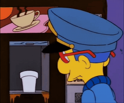 Man In Blue Hat Looking At Coffee Machine GIF
