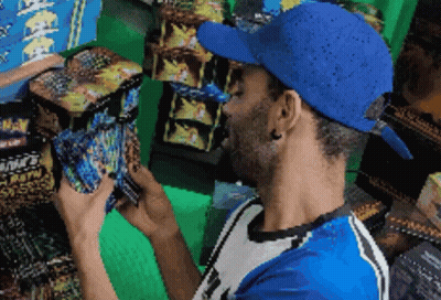 Man In Blue Hat Looking At Fireworks Box GIF