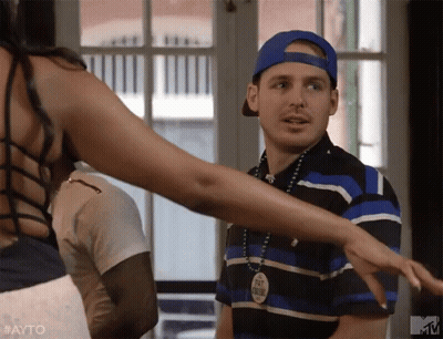 Man In Blue Hat Next To Woman In Black Top GIF