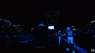 Man In Blue Hat On Football Field With Crowd GIF