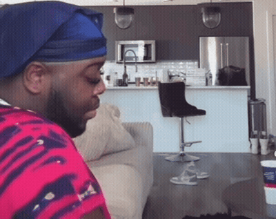 Man In Blue Hat Sitting GIF