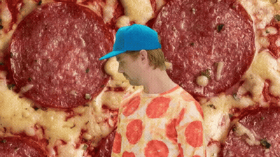 Man In Blue Hat Standing In Front Of Pizza GIF