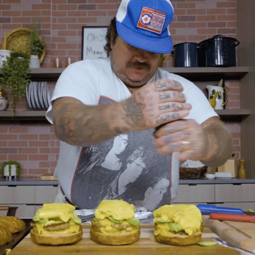 Man In Blue Hat With Chicago Prepares Hamburgers GIF