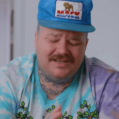 Man In Blue Hat With Mack Patch GIF