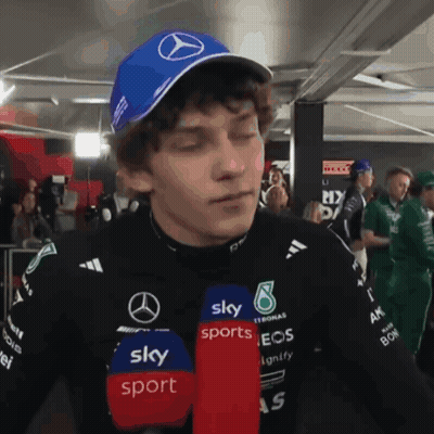 Man In Blue Hat With Mercedes Logo Talking Into Microphone For Sky Sports GIF