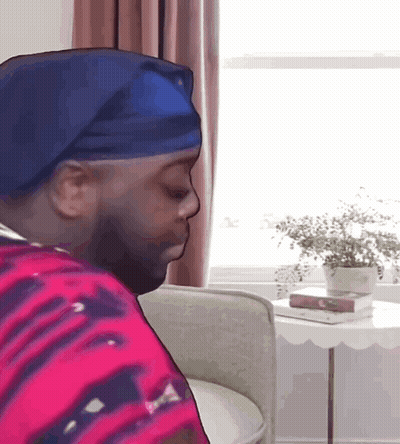 Man In Blue Headband Sitting GIF