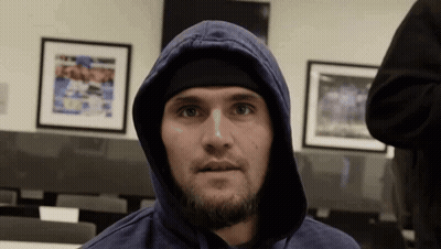 Man In Blue Hoodie And Black Headband Looking At Camera GIF