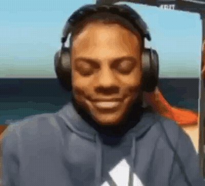 Man In Blue Hoodie Smiling With Headphones GIF