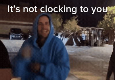 Man In Blue Hoodie Standing Before Sign GIF