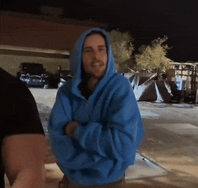 Man In Blue Hoodie Standing In Parking Lot GIF