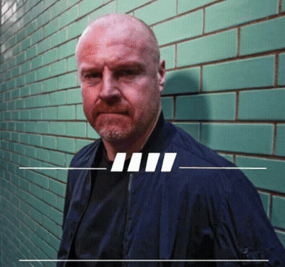 Man In Blue Jacket And Green Tiled Wall GIF