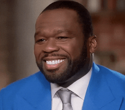 Man In Blue Jacket And Tie Smiles GIF