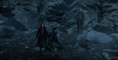 Man In Blue Jacket At Rock Wall GIF