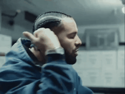 Man In Blue Jacket Braiding Hair GIF