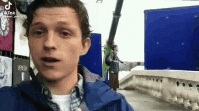 Man In Blue Jacket By Blue Building GIF