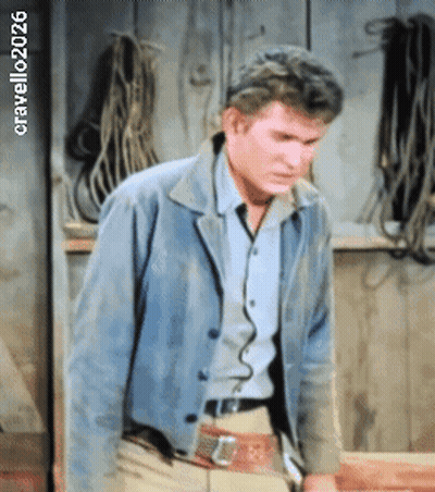 Man In Blue Jacket By Wall With Ropes 2026 GIF