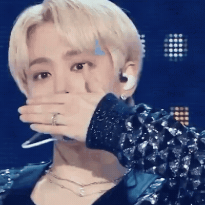 Man In Blue Jacket Covering Mouth GIF