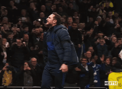 Man In Blue Jacket Dancing In Front Of Crowd With Yellow Vest Saying Heitse GIF