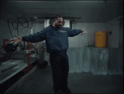 Man In Blue Jacket Dancing With Ice Blocks GIF