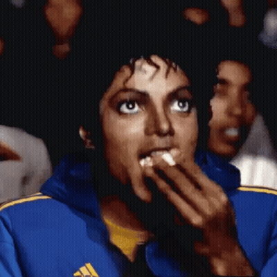Man In Blue Jacket Eating Popcorn While Watching Movie GIF