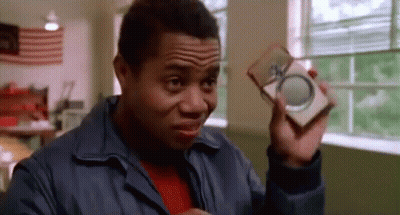 Man In Blue Jacket Holding Box And Magnifying Glass GIF