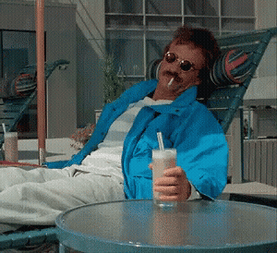Man In Blue Jacket Holding Drink GIF