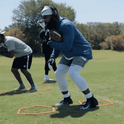Man In Blue Jacket Holding Football GIF