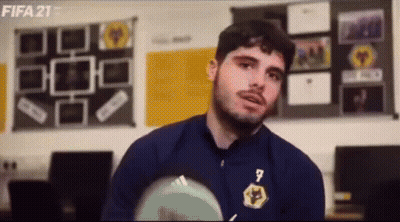 Man In Blue Jacket Holding Soccer Ball Talking GIF