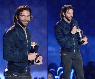 Man In Blue Jacket Holding Trophy And Microphone GIF