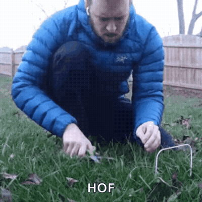 Man In Blue Jacket Holding Wire GIF