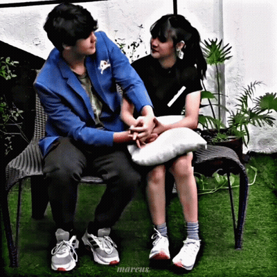 Man In Blue Jacket Holding Woman's Hand On Bench GIF